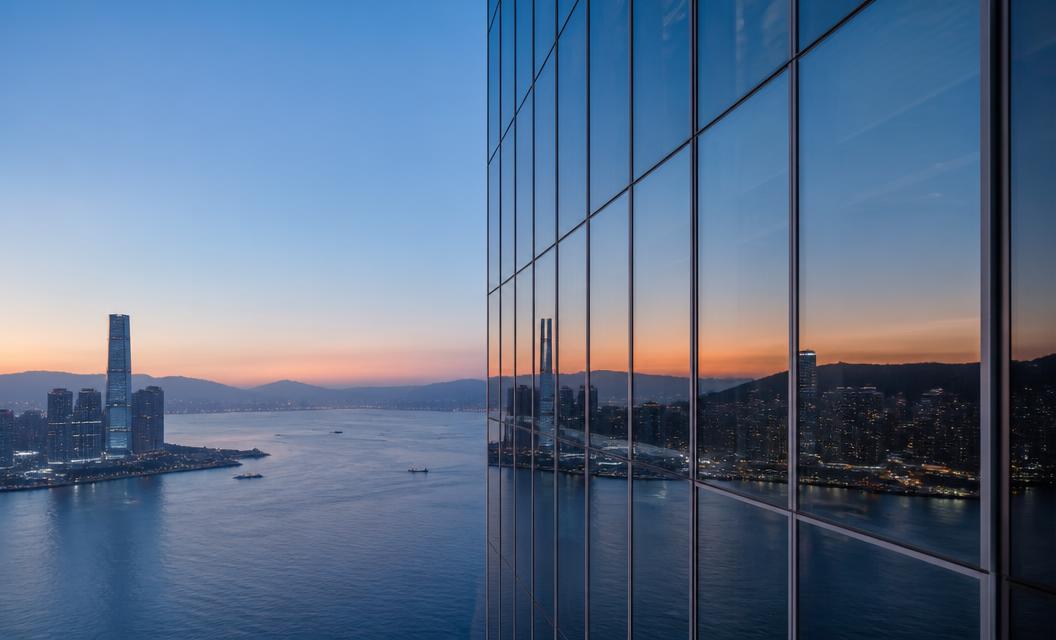 Hong Kong skyscrapers reflecting Victoria Harbour at dusk